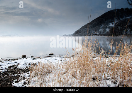 Tôt le matin dans la brume sur Ullswater Lake District sur un froid matin d'hiver. Banque D'Images