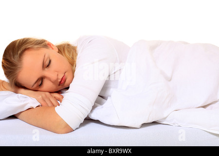 Attractive blonde woman sleeping in bed. Le tout sur fond blanc. Banque D'Images