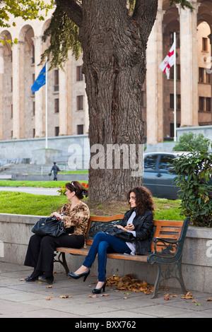 Deux femmes assises sur le banc de la Géorgie à l'extérieur de bâtiment du Parlement européen, Gamziri Rustavelis de Tbilissi, Géorgie. JMH4034 Banque D'Images