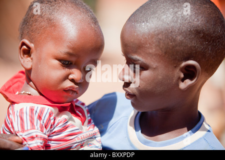 Un garçon Peul tient son jeune frère à Djibo, le nord du Burkina Faso. Banque D'Images