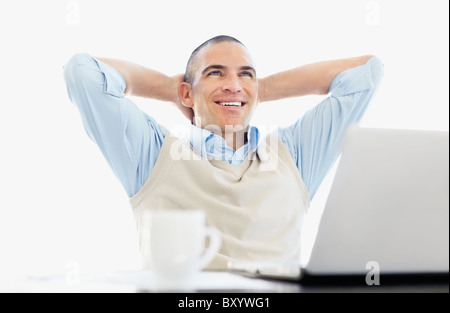 Cheerful office worker with hands behind back Banque D'Images