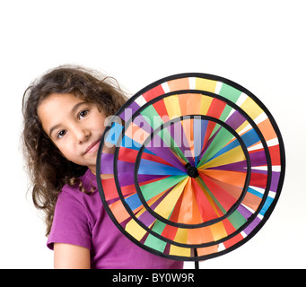 Young Girl holding a pinwheel isolated on white Banque D'Images