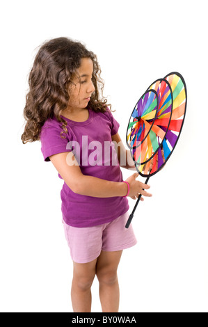 Young Girl holding a pinwheel isolated on white Banque D'Images