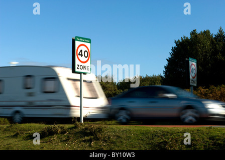 Une voiture et caravane passant montrant la signalisation il y a une limite de vitesse de 40 mi/h dans le parc national New Forest Banque D'Images