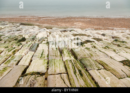 La défense de la mer a jeté des pierres sur la plage sont usés par l'action de l'eau Banque D'Images