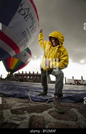 Un homme tire un ballon alors qu'il est gonflé dans le Centro Ceremonial Otomi, État de Mexico, Mexique. Banque D'Images