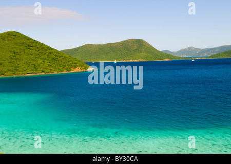 LEINSTER BAY, assuré John, Îles Vierges américaines — Une vue panoramique sur la baie de Leinster sur le lieu sûr John, Îles Vierges américaines, met en valeur le paysage caribéen. De gauche à droite, la vue englobe Mary point, Great Thatch Island, et au loin, Jost Van Dyke dans les îles Vierges britanniques. La scène met en évidence la proximité et la connexion visuelle entre les États-Unis et les îles Vierges britanniques. Banque D'Images