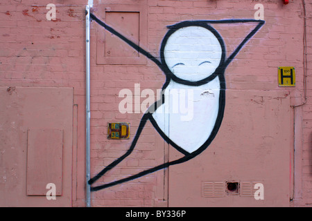 Les graffitis de rue d'un caractère sur un mur bord rose Banque D'Images