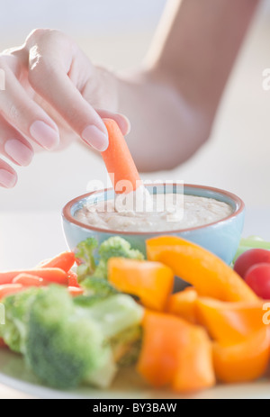 USA, New Jersey, Jersey City, Close-up view of woman putting baby carrot en plongeon Banque D'Images