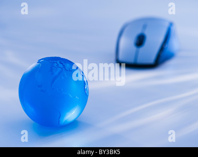 Vue rapprochée de la souris de l'ordinateur et globe bleu Banque D'Images