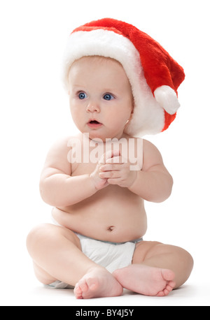 Petite séance baby in Santa cap à côté avec grand étonnement Banque D'Images