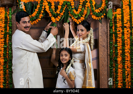 South Indian family decorating pendant Onam festival Banque D'Images