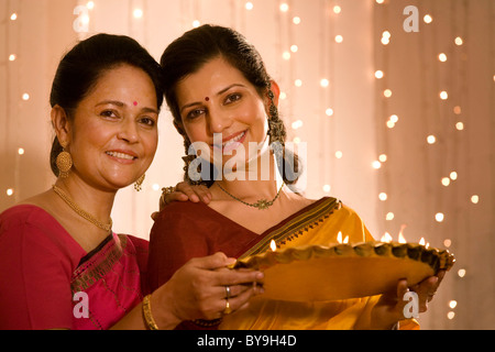 Mère et fille avec un plateau de diyas Banque D'Images