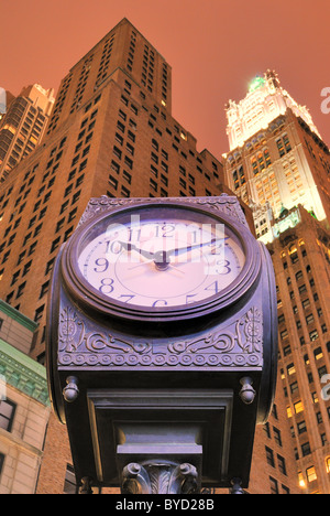 Une vieille horloge mode au centre-ville de Manhattan avec un skysrcrapers derrière elle. Banque D'Images