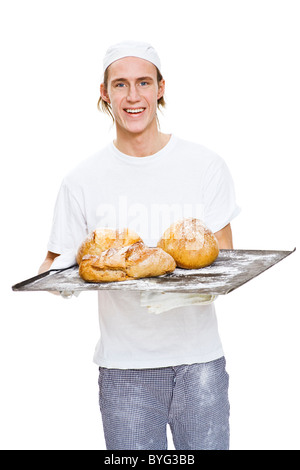 Studio portrait of male baker holding tray with pain Banque D'Images