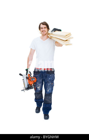 Studio shot of carpenter carrying lumber Banque D'Images