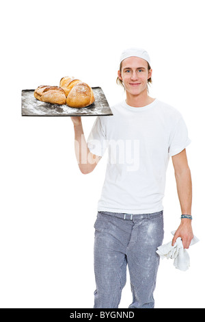 Studio portrait of male baker holding tray with pain Banque D'Images