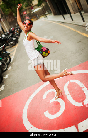 Portrait of woman walking in street Banque D'Images