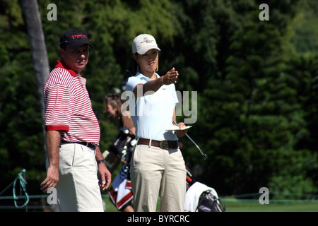 Le golfeur de 15 ans Michelle Wie parle à son caddy pendant une ronde de pratique avant le Sony Open 2005 à Hawaii. Banque D'Images