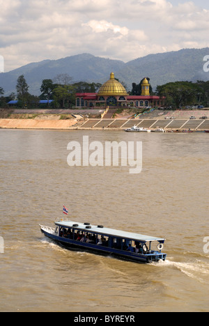 Un bateau de tourisme sur le Mékong, en face d'un casino appartenant à des Chinois au Laos. Banque D'Images