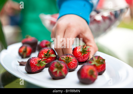 Quelqu'un d'attraper un chocolat au lait fraise. Banque D'Images