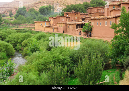 Petit village berbère, avec des maisons en torchis sur une rivière avec une végétation luxuriante, Kelaa M'gouna, Haut Atlas, Maroc, Afrique Banque D'Images