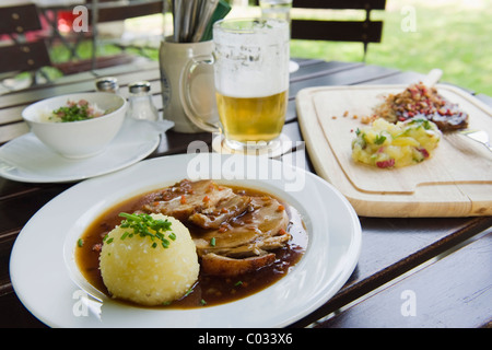 Rôti de porc aux pommes de terre et d'une boulette un verre de bière dans un café en plein air, une cuisine bavaroise, Bavaria, Germany, Europe Banque D'Images