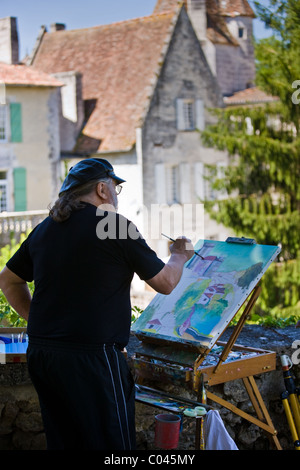 Peinture artiste ville de Bourdeilles destination touristique populaire près de Brantôme, dans le Nord de la Dordogne, France Banque D'Images