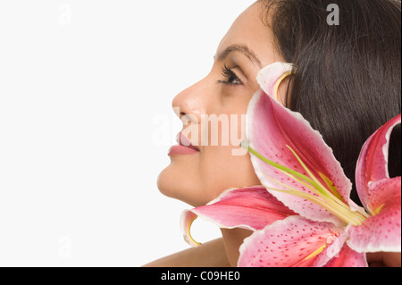 Close-up of a woman with Tiger Lily flower Banque D'Images