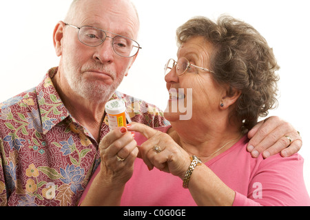 Senior Couple lit une bouteille de Prescription avec plaisir regard sur leurs visages tous sur un fond blanc. Banque D'Images