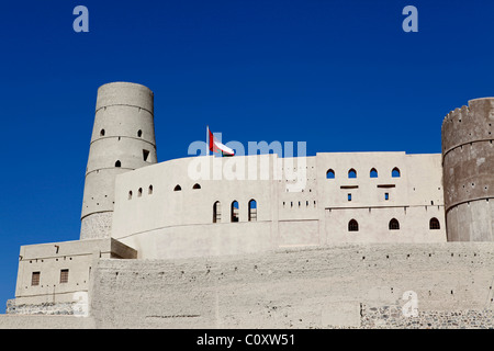 Le drapeau omanais vole au-dessus de Fort de Bahla en Oman. Banque D'Images