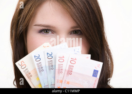 Femme avec un ventilateur de billets de banque Banque D'Images