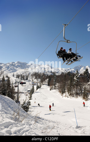 Skieurs sur un télésiège au centre de ski de Vogel dans le parc national du Triglav de Slovénie Mont montagne Banque D'Images