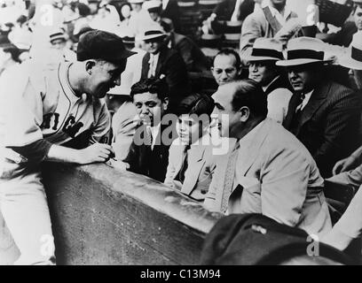 Chicago Cubs Gabby Hartnett joueur de baseball de signatures pour Sonny Capone qui est assis avec son père Al Capone et autres gangsters à un organisme de bienfaisance 1931 match de baseball. Banque D'Images