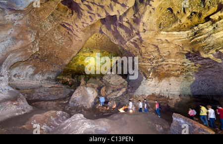 Cave les touristes : Un groupe de touristes sur une visite guidée de l'Loltu. Un groupe de 8 touristes suit un guide à travers une caverne massive Banque D'Images