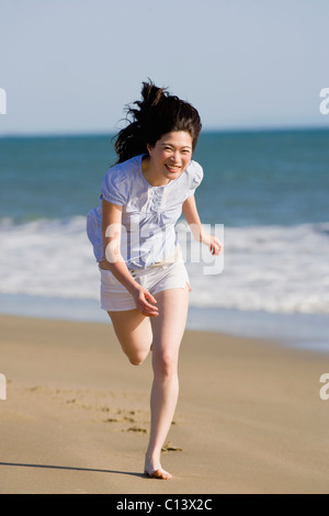 États-unis, Californie, Point Reyes, young woman running on beach Banque D'Images