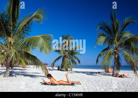 Femme lisant, plage de sable fin, palmiers, Smathers Beach, Key West, les clés, Florida, USA Banque D'Images