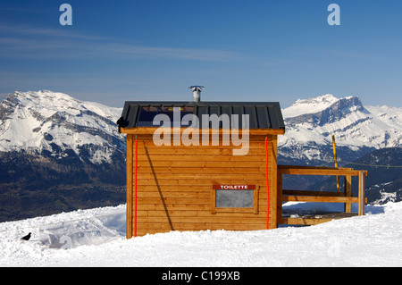 Toilettes hut sur le côté d'un cours de ski dans le domaine skiable de Saint-Gervais, Savoie, France, Europe Banque D'Images