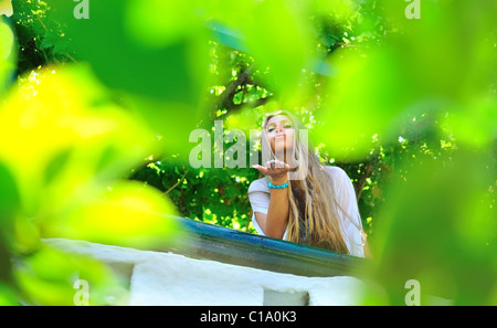 Belle fille jeter un baiser d'un balcon Banque D'Images