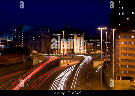 Sentiers de feux de circulation de véhicules voyageant trop et de la ville de Leeds uk yorkshire de nuit Banque D'Images