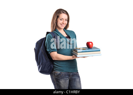 A smiling female student holding books et une pomme rouge Banque D'Images