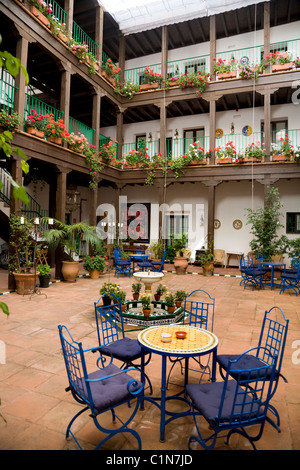 Intérieur / cour intérieure et table/chaises d'Hôtel / Auberge / dans la vieille ville historique de Séville. L'Espagne. Banque D'Images