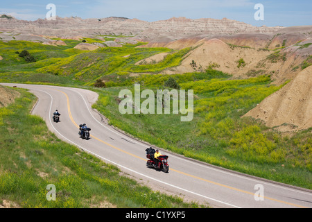 Motorcyclits à cheval sur leur Harley-Davidsons dans le parc national de Badlands, Dakota du Sud, États-Unis. Banque D'Images