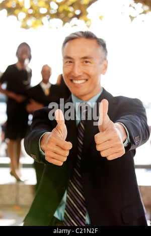 Un business man with Thumbs up - critique l'accent sur le pouce Banque D'Images