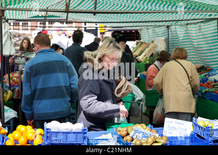 Clients au marché de fruits et légumes en décrochage town square Banque D'Images