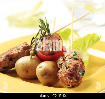 Brochettes de viande hachée et de pommes de terre nouvelles sur des bâtons Banque D'Images