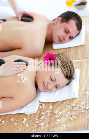 Jeune couple bénéficiant d'un massage de dos avec de la pierre Banque D'Images