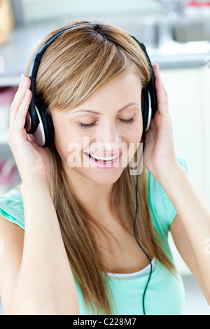 Femme animée d'écouter la musique avec des écouteurs Banque D'Images