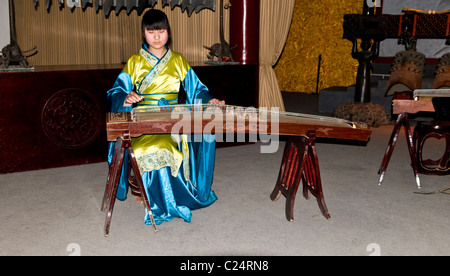 Un musicien chinois jouant le Zheng- un instrument à cordes traditionnel chinois. Banque D'Images