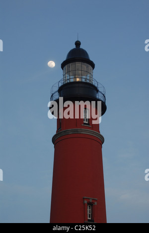 La lune se lève derrière un phare de Ponce Inlet, en Floride. Banque D'Images